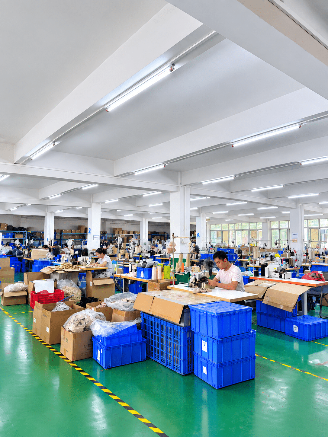 Insole manufacturing factory with workers assembling and processing insoles