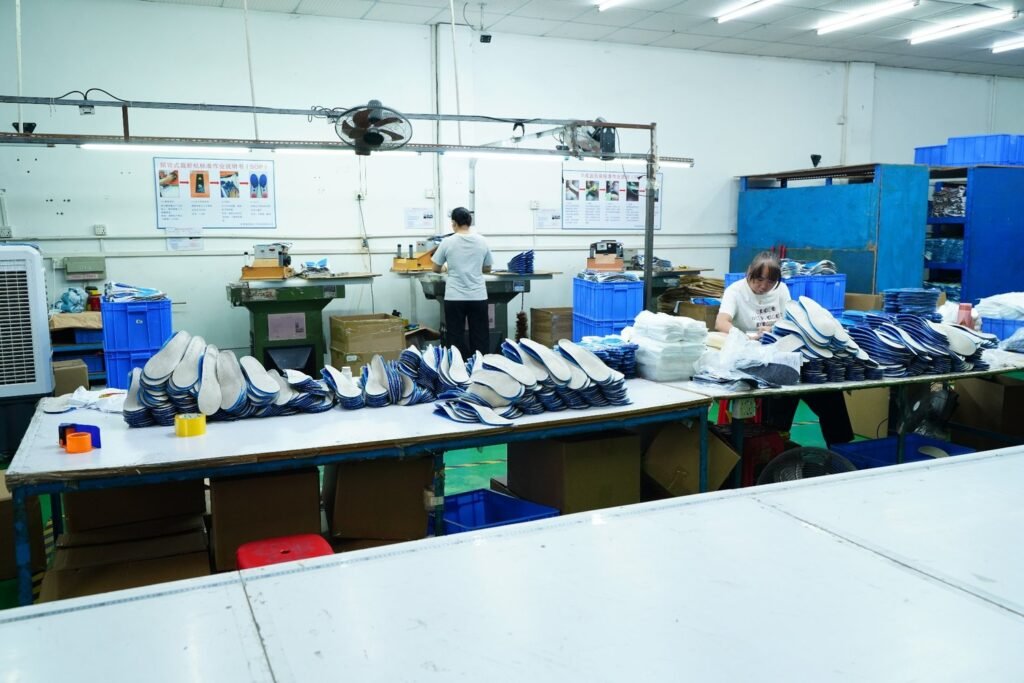 Insole manufacturing production line with workers processing custom shoe insoles